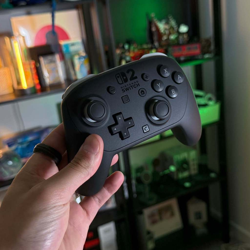 A hand holding a video game controller